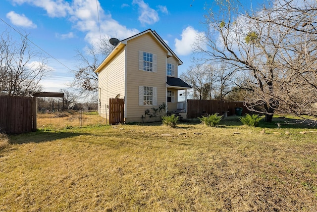 rear view of property featuring a yard