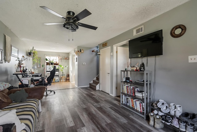 office area with ceiling fan, dark hardwood / wood-style floors, and a textured ceiling