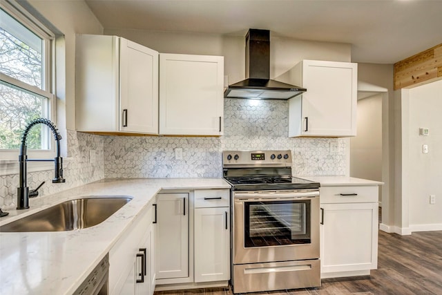 kitchen with electric stove, white cabinetry, wall chimney exhaust hood, and sink