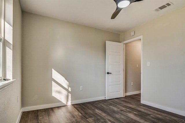 spare room featuring ceiling fan and dark hardwood / wood-style floors