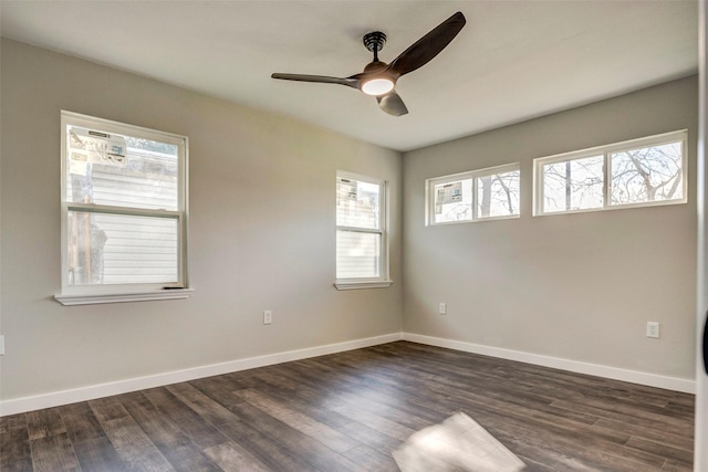 spare room featuring ceiling fan, dark hardwood / wood-style flooring, and plenty of natural light