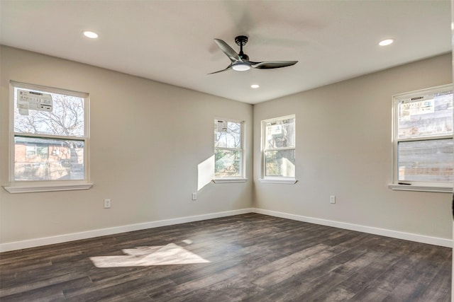 spare room with dark wood-type flooring and ceiling fan