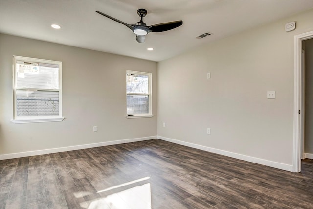 spare room with ceiling fan and dark hardwood / wood-style floors