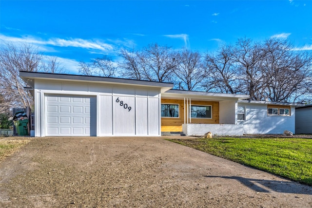 view of front of property with a garage and a front lawn