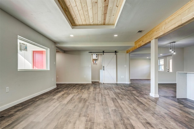 interior space featuring wooden ceiling, a barn door, and wood-type flooring