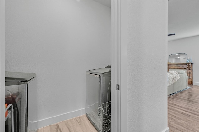 laundry room featuring light hardwood / wood-style flooring and washer and clothes dryer