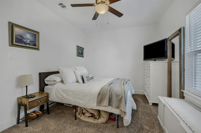 bedroom with ceiling fan and dark colored carpet