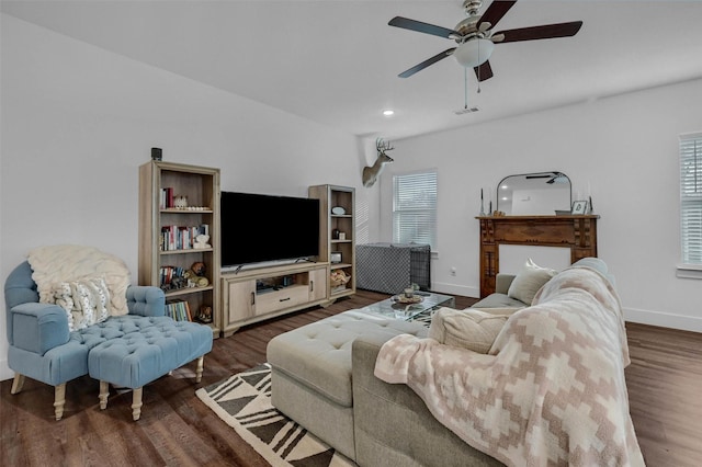 living room with ceiling fan and dark hardwood / wood-style flooring