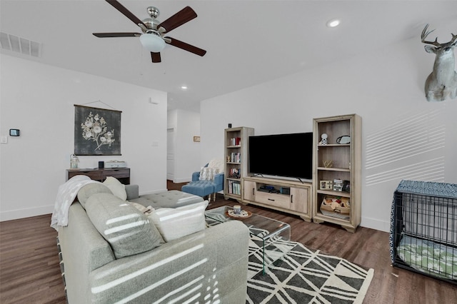 living room with ceiling fan and dark hardwood / wood-style flooring