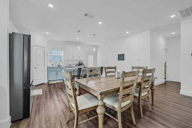 dining space featuring dark hardwood / wood-style flooring and sink