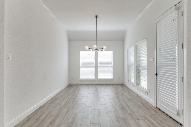 unfurnished dining area featuring a healthy amount of sunlight, crown molding, and a chandelier