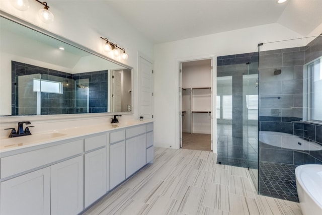 bathroom featuring lofted ceiling, vanity, and shower with separate bathtub