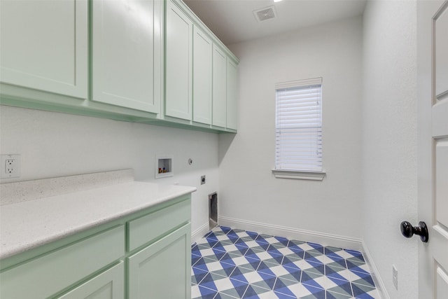 clothes washing area featuring cabinets, hookup for a washing machine, and hookup for an electric dryer