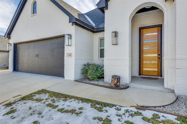 view of exterior entry with a garage