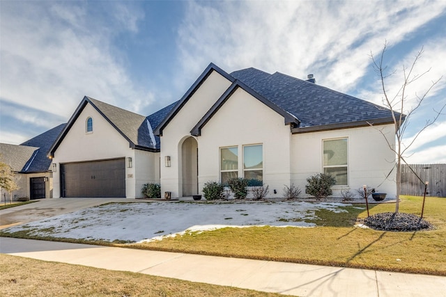 view of front of property with a front yard and a garage