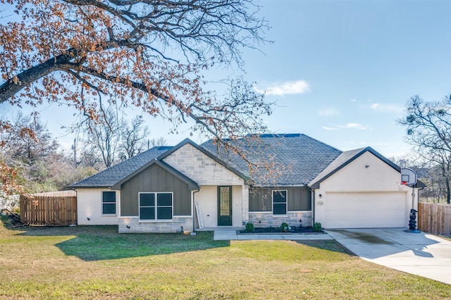 view of front of property featuring a front yard and a garage