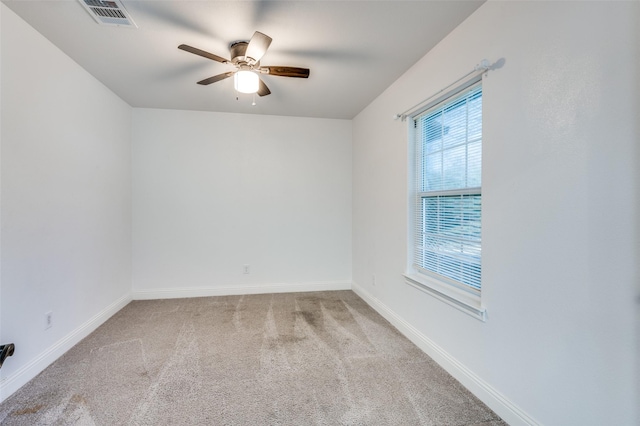 carpeted spare room featuring ceiling fan