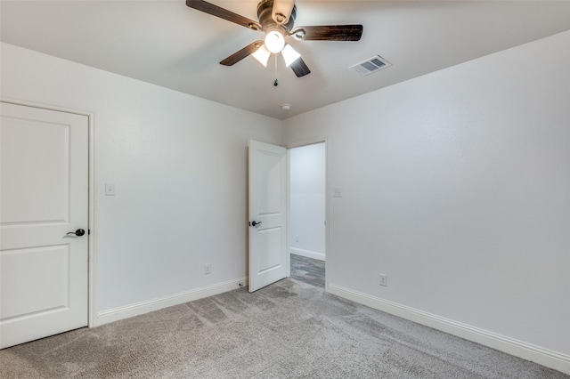 carpeted spare room with ceiling fan