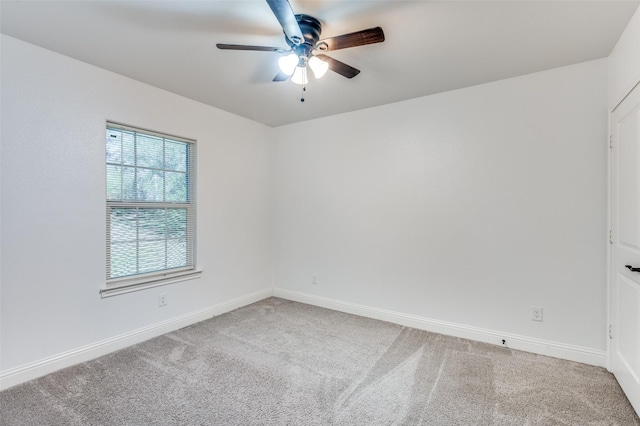 carpeted spare room with ceiling fan