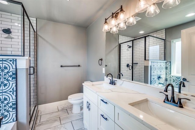 bathroom featuring toilet, a shower with door, and vanity