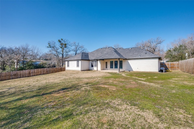 rear view of property featuring a lawn