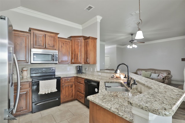 kitchen with sink, kitchen peninsula, light stone countertops, and black appliances