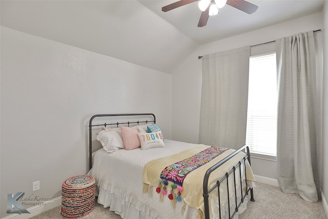 bedroom with lofted ceiling, ceiling fan, and light colored carpet