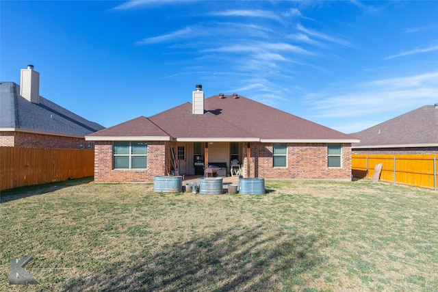 rear view of house with a yard and a patio area