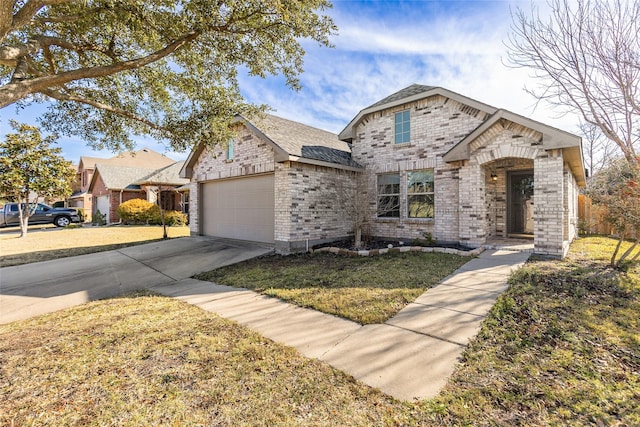 view of front of house with a garage and a front lawn