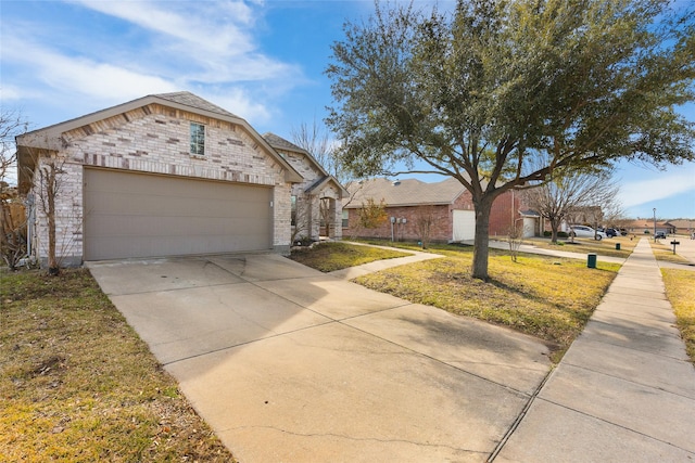 ranch-style home featuring a front lawn and a garage