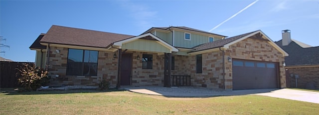 view of front of property with a front yard and a garage