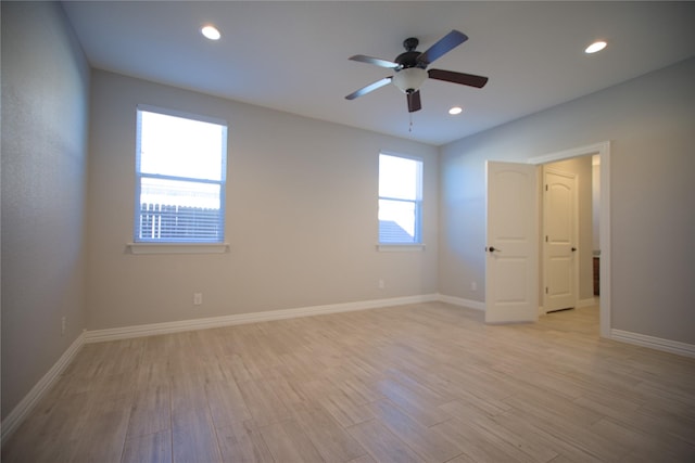 empty room with light hardwood / wood-style floors and ceiling fan