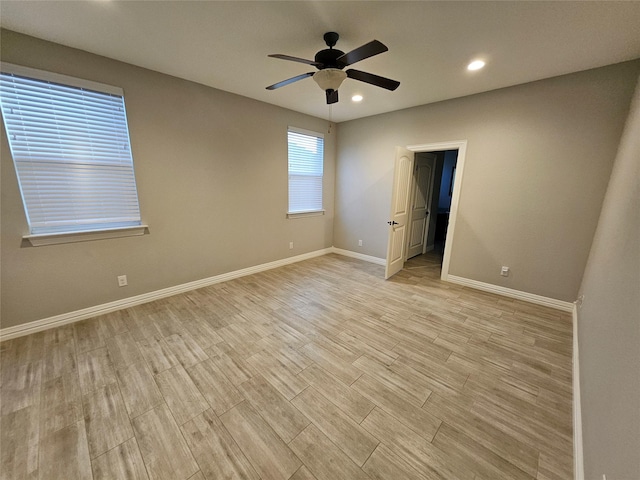 empty room featuring ceiling fan and light hardwood / wood-style flooring