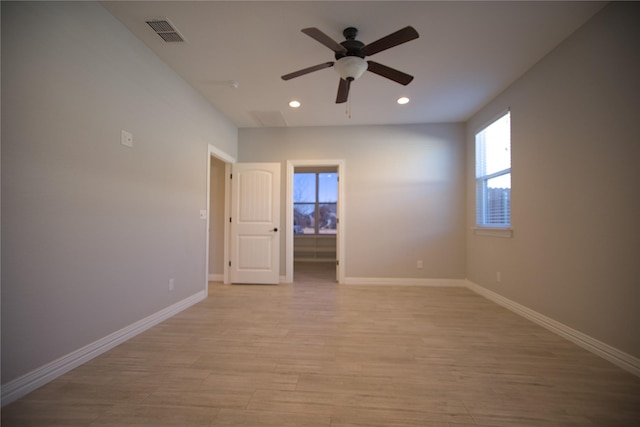 empty room featuring ceiling fan and light hardwood / wood-style floors