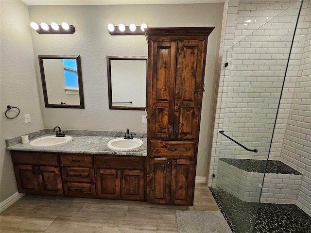 bathroom with vanity and a tile shower