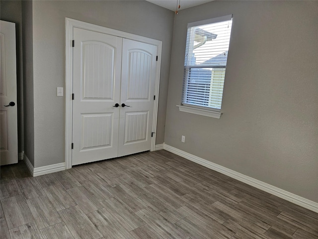 unfurnished bedroom featuring a closet and light hardwood / wood-style flooring