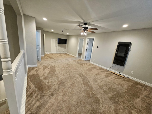 unfurnished living room with carpet floors and ceiling fan