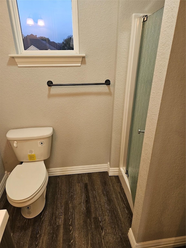 bathroom with toilet and hardwood / wood-style flooring