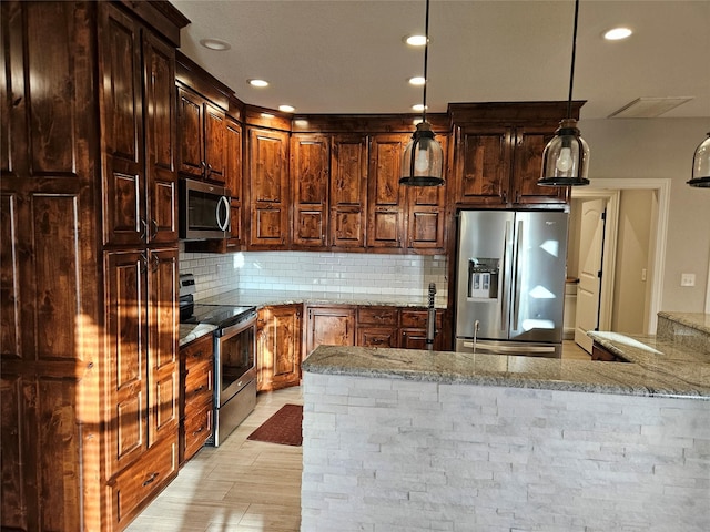 kitchen with tasteful backsplash, pendant lighting, kitchen peninsula, stainless steel appliances, and light stone counters