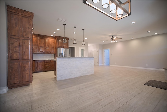 kitchen with a center island, decorative light fixtures, tasteful backsplash, stainless steel fridge with ice dispenser, and ceiling fan