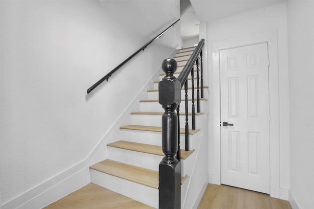 stairway featuring hardwood / wood-style flooring