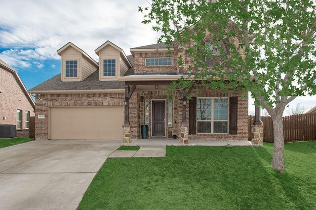 view of front of property with cooling unit, a garage, and a front yard