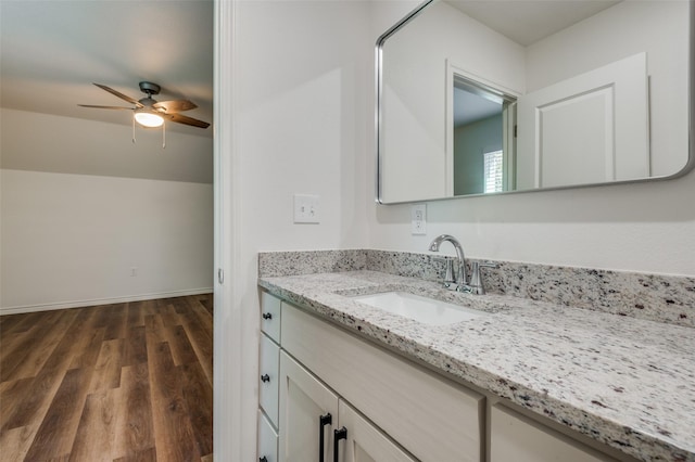 bathroom featuring vanity, wood-type flooring, ceiling fan, and vaulted ceiling