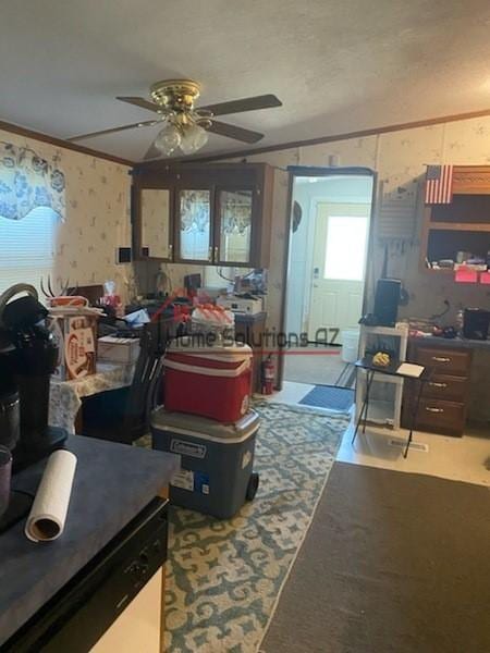 interior space featuring ceiling fan and crown molding