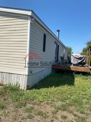 view of side of home featuring a wooden deck