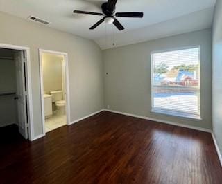 unfurnished bedroom with ceiling fan, dark hardwood / wood-style flooring, ensuite bathroom, and multiple windows