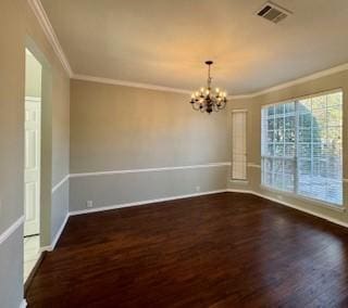 spare room featuring ornamental molding, a chandelier, and dark hardwood / wood-style floors