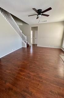 spare room with ceiling fan and dark wood-type flooring