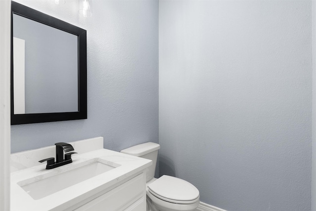 bathroom featuring toilet and vanity