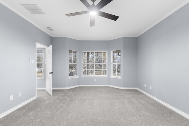 unfurnished room with ceiling fan, crown molding, and carpet flooring